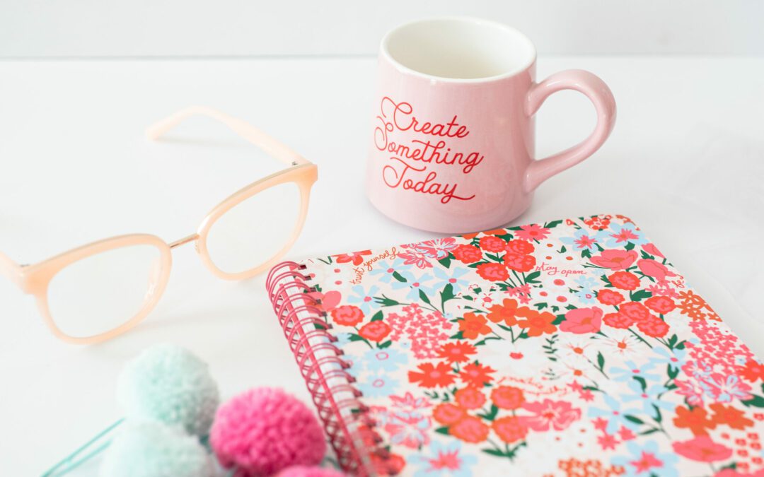 Image of notebook, mug and glasses used by a content strategist